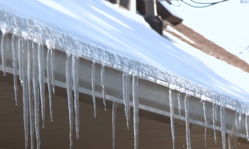 Icicles hanging from the edge of a house roof